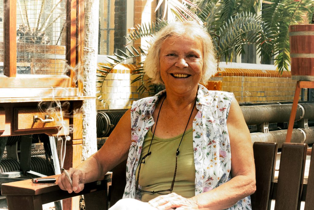 Mila Jansen sitting with a cannabis joint in her hand